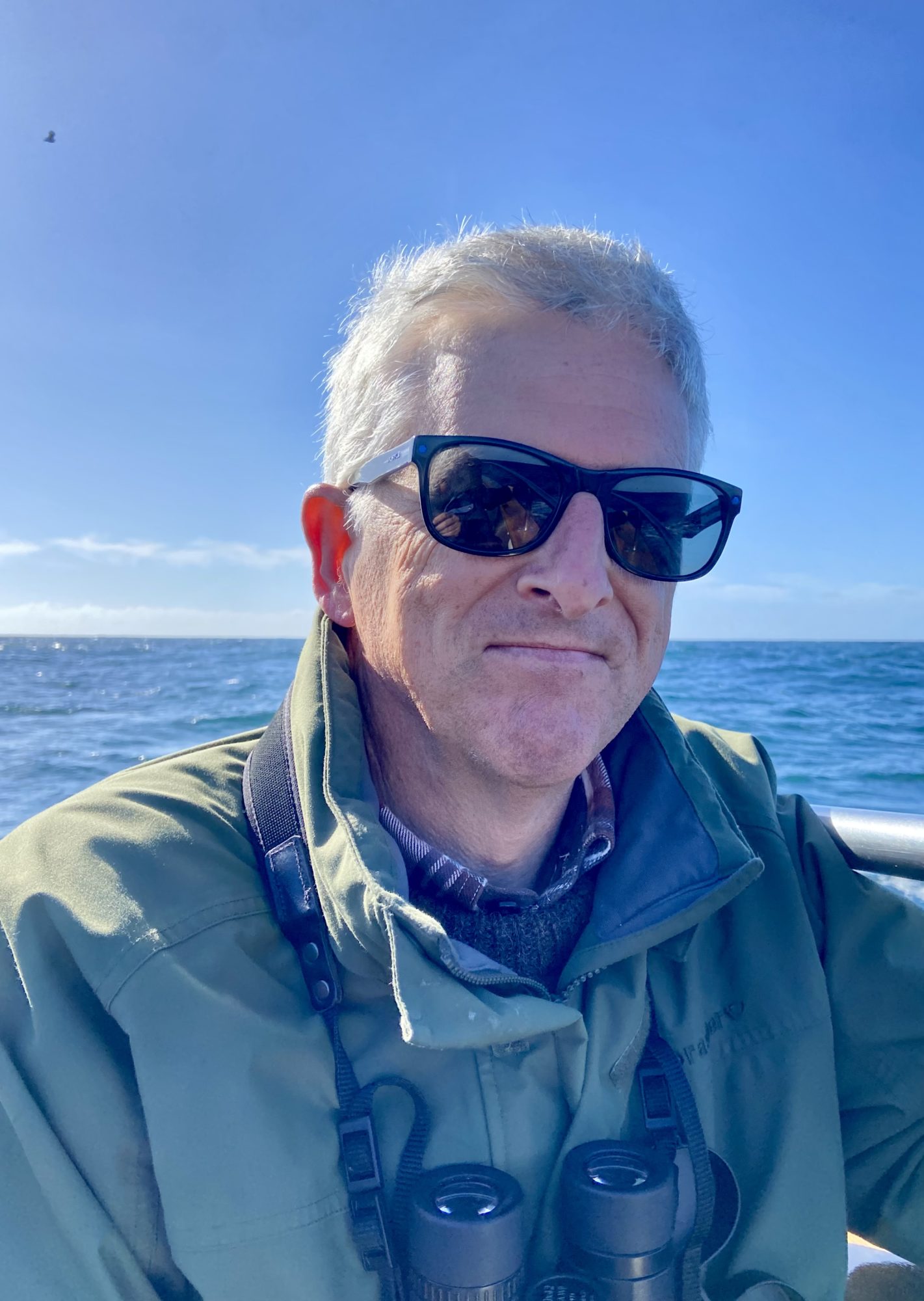 Portrait shot of Wylie Horn with the sea and blue sky in the background