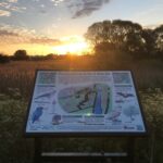 A nature reserve information board a dawn